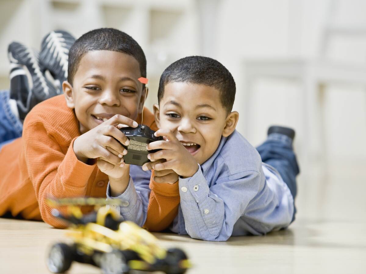 Two children playing with remote controlled car