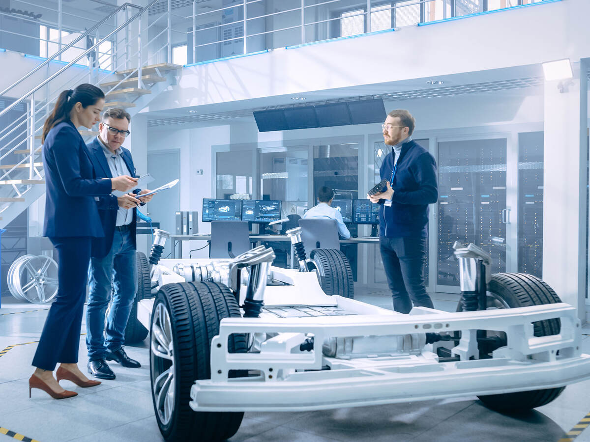 People working around an electric car