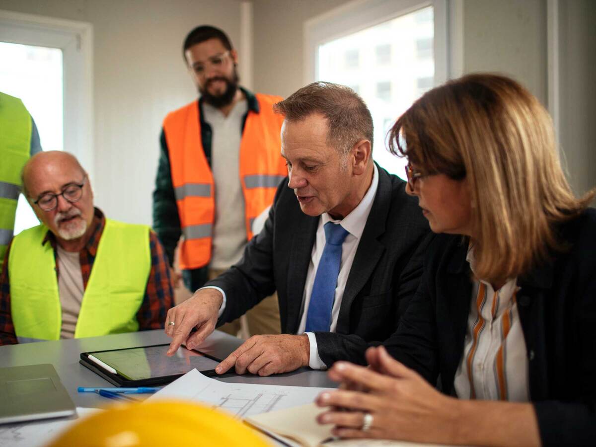 Board directors having a meeting with the team in the office at the construction site