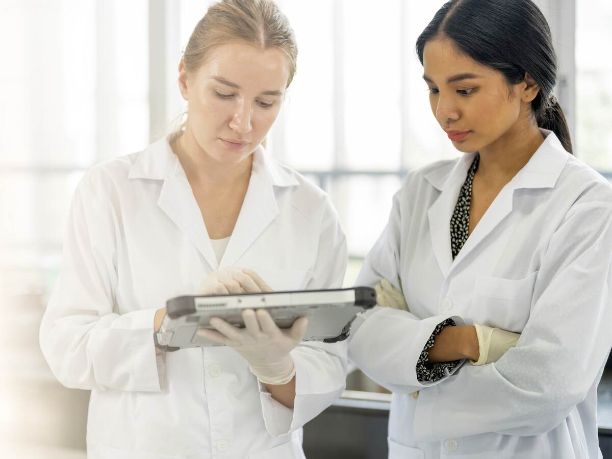 Scientists working in Laboratory having discussion on testing data together.