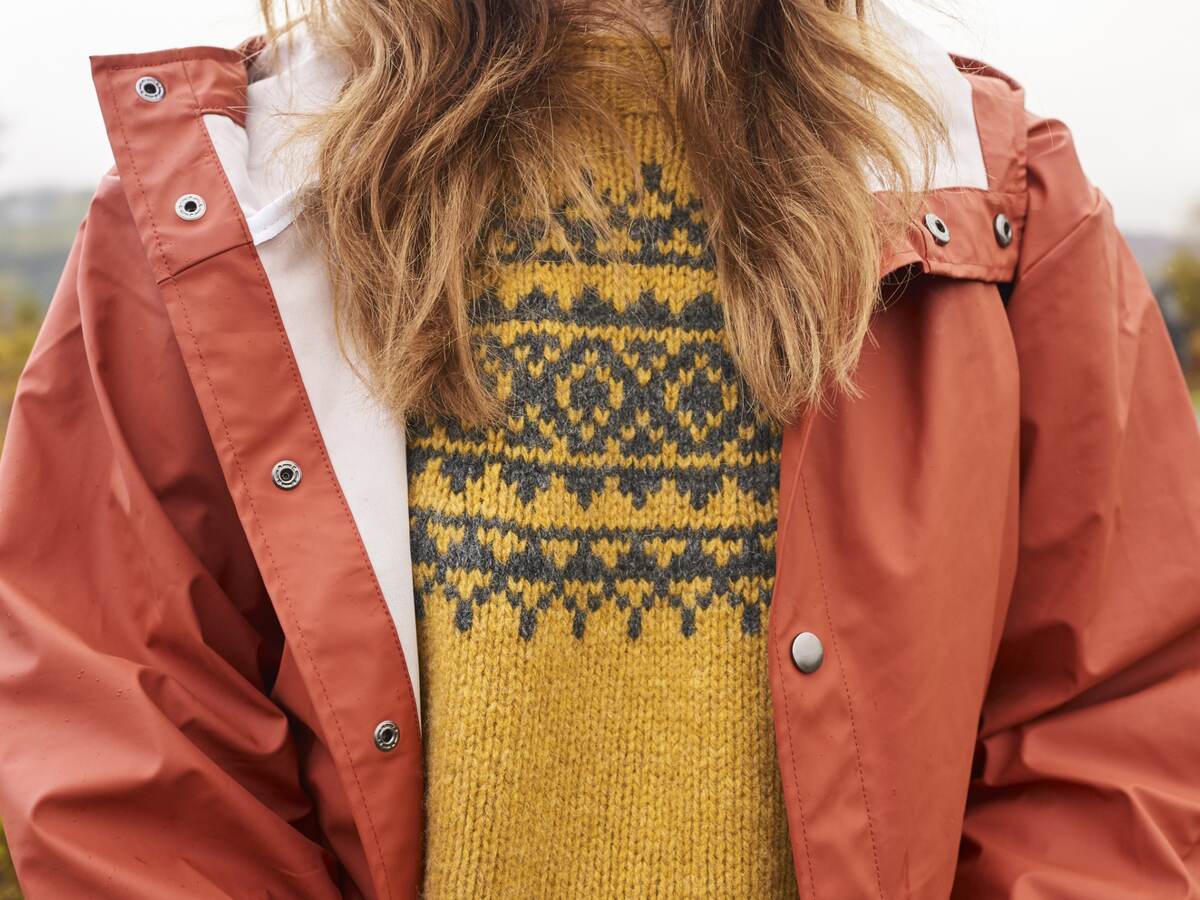 Woman in jumper and waterproof jacket