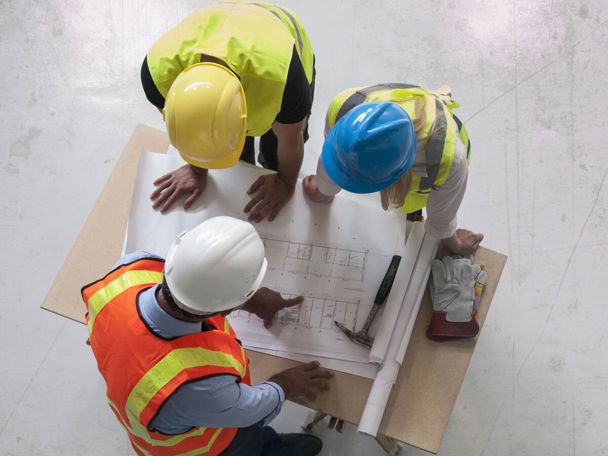 Contractors reviewing blueprints