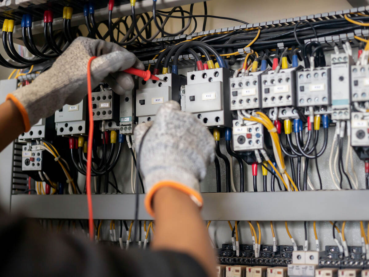 Engineer using multimeter