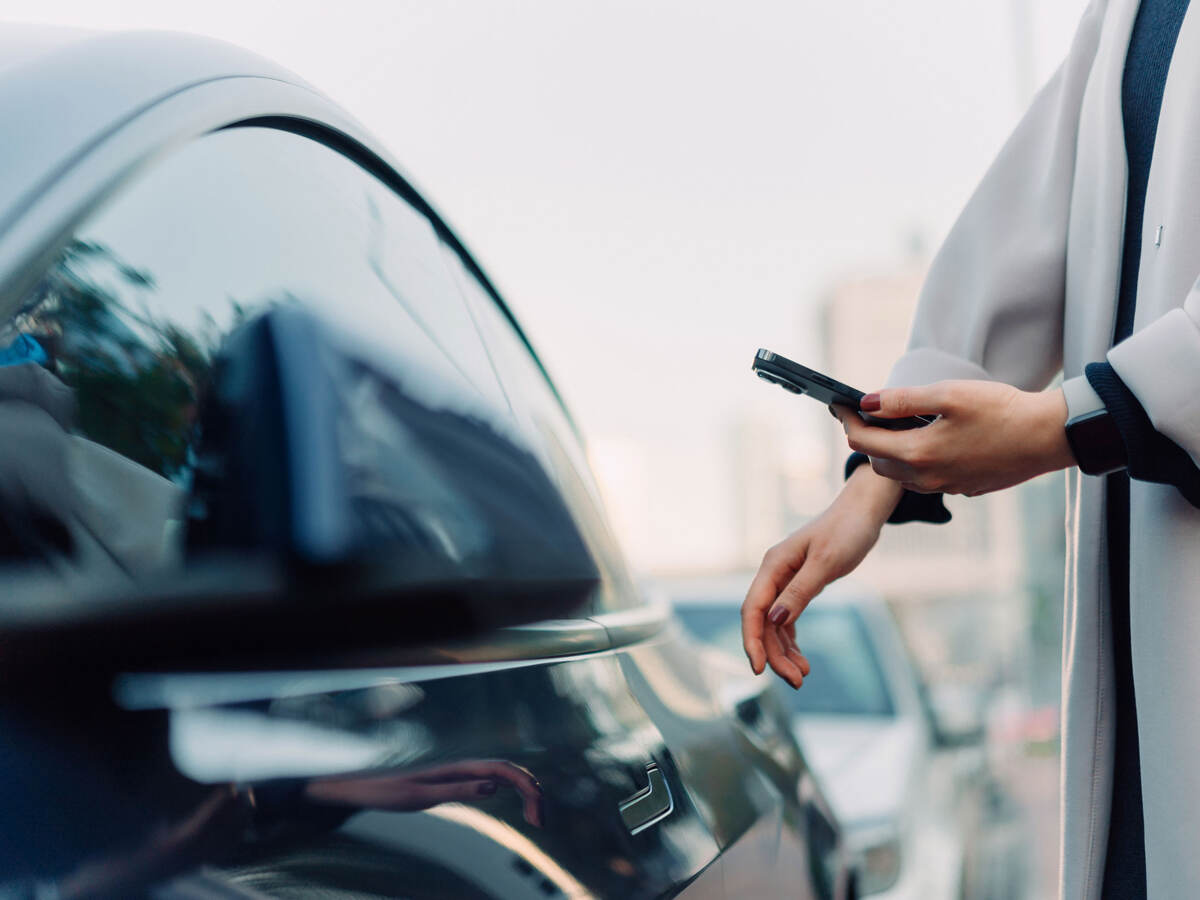 A person looking at an app for their smart vehicle