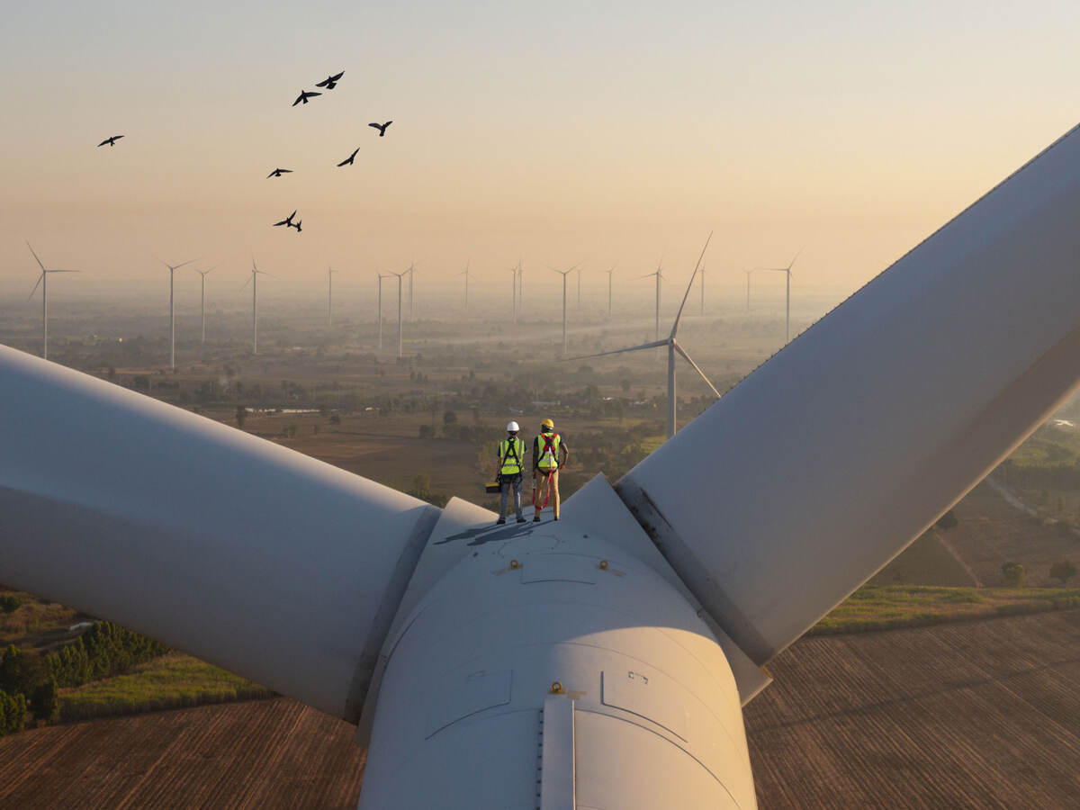 Two engineers on top of a wind turbine