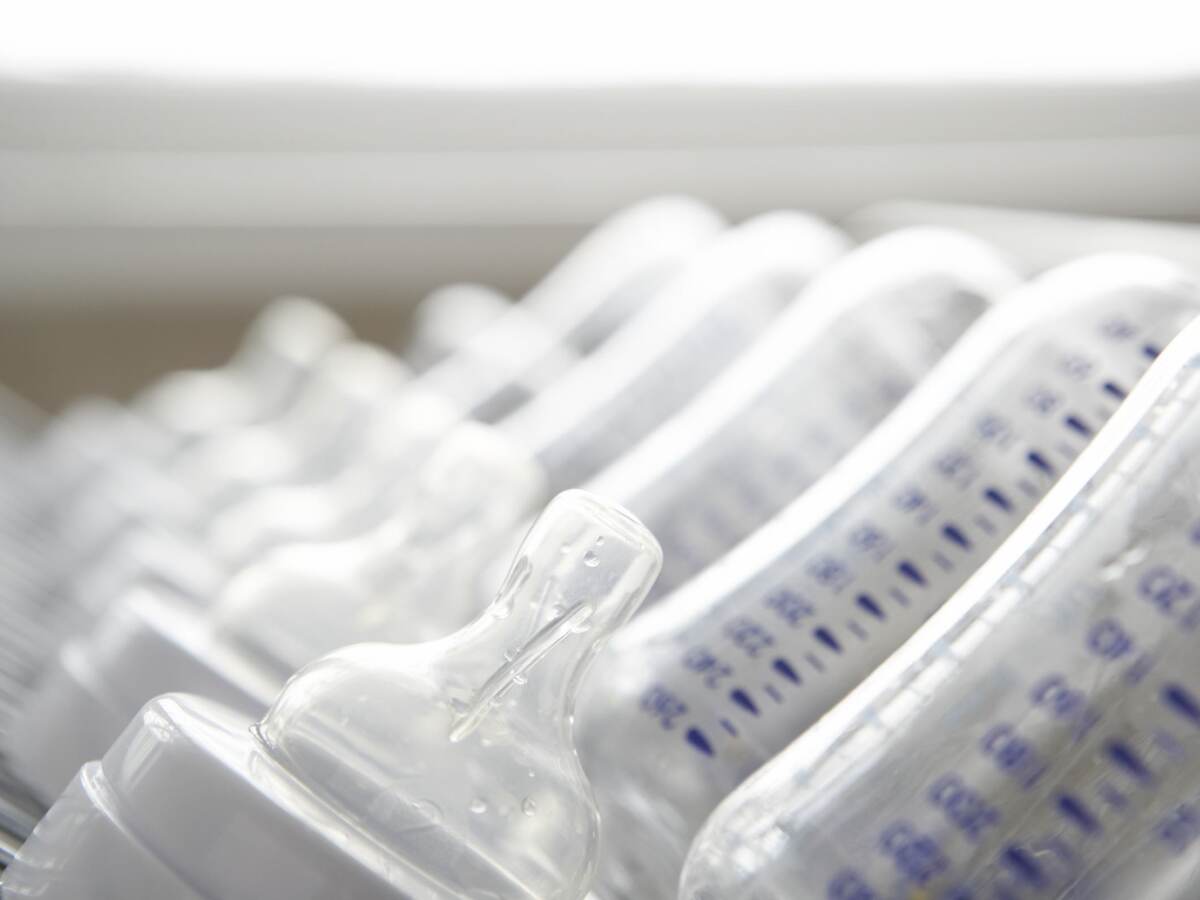 Baby's bottles on drying rack, close-up