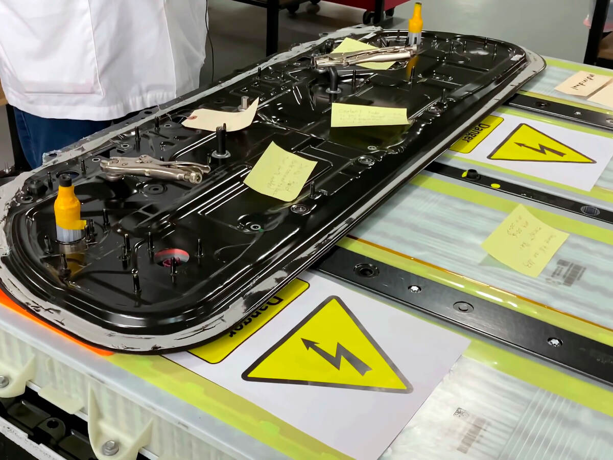 Close-up of a mechanic repairing an electric car battery