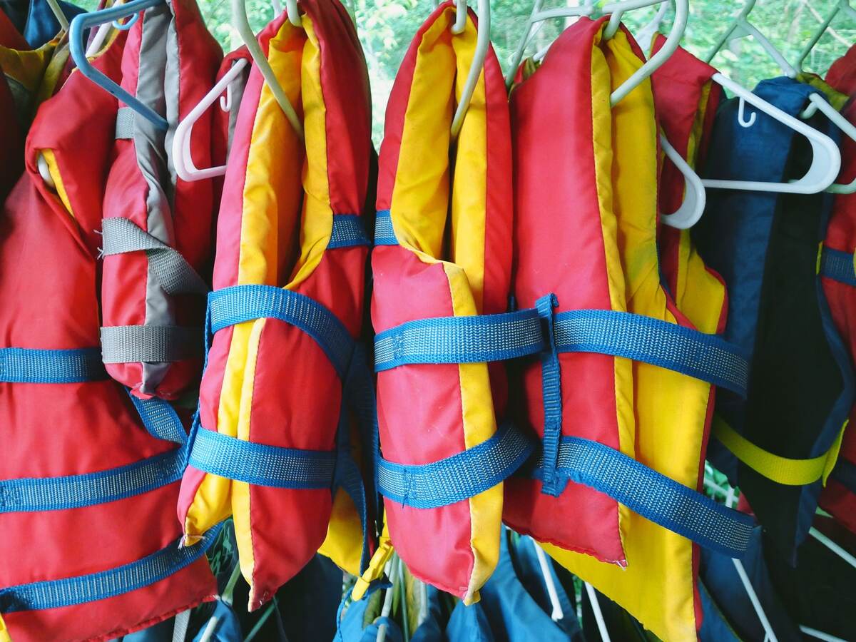 Colorful life jackets hanging in a row