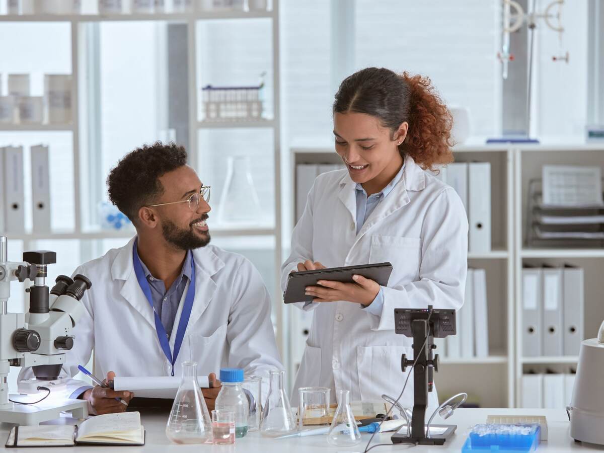 Shot of two young scientists working together in a lab