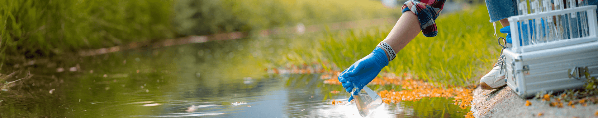 scientist collecting water sample from a lake