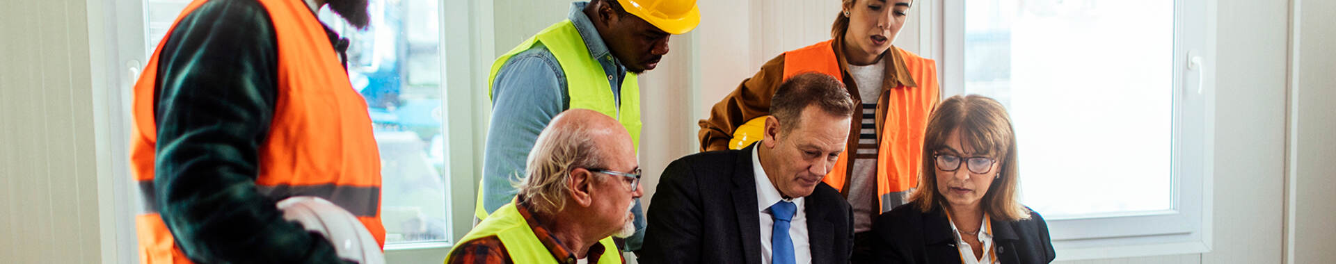 people in protective gear in a meeting