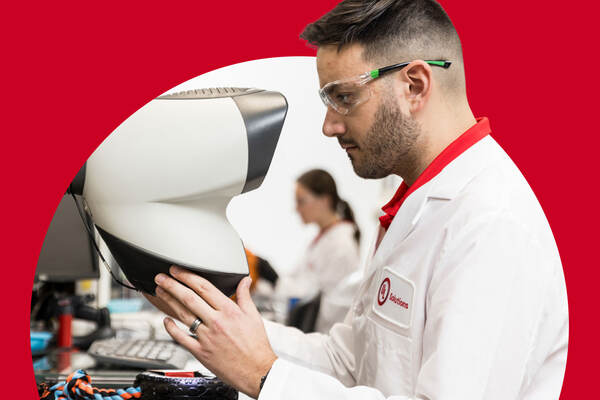 UL Solutions scientist wearing appropriate PPE holding a 3D microscope