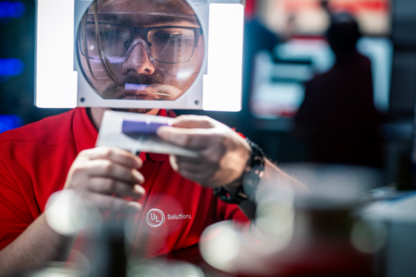 UL Solutions employee inspecting an object using an illuminate magnifier