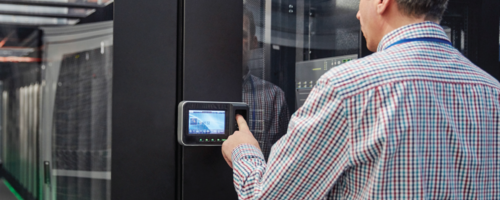 Person with wall-mounted touchscreen smart device